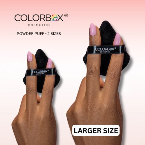 Colorbox Cosmetics powder puff on fingers with 'Larger Size' label against a pink background