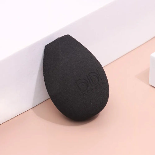 Three makeup sponges on a light pink and white background