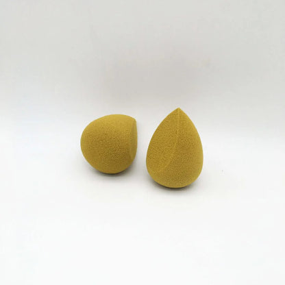 Two yellow teardrop-shaped sponges on a white background
