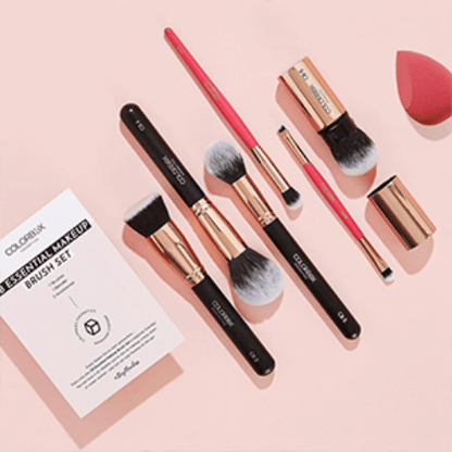 Makeup brush set with a Colorfuluk branded card on a pink background