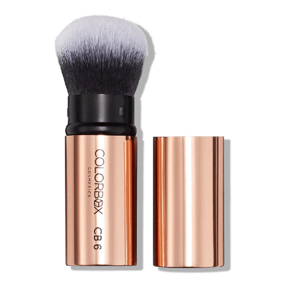Makeup brush with rose gold handle and black bristles on a white background