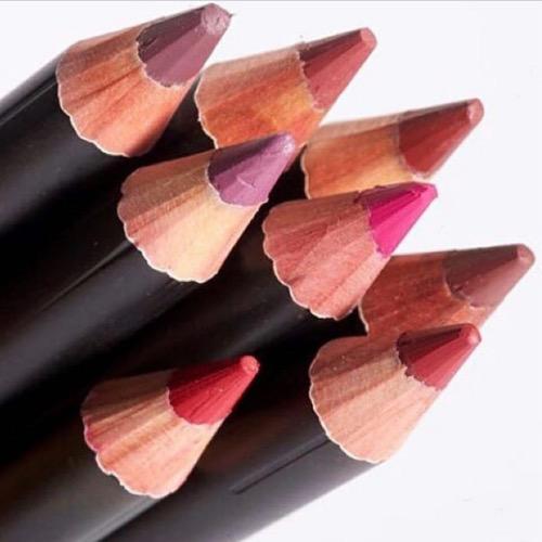 Close-up of colored pencil tips on a white background